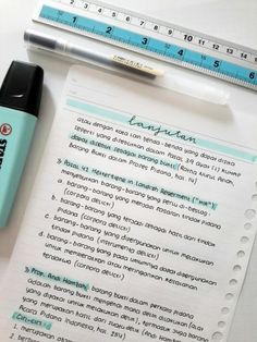 a pen, ruler and paper on top of a white table with writing in it