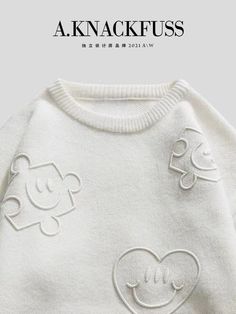 a white sweater with mickey mouses on the front and back, as well as an image