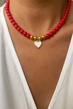 The heart at the end is gold plated and the white part is created with enamel, the beads used are glass.  The length of the necklace is 15,7 inch. Gold Beaded Necklaces With Heart Charm And Round Beads, Gold Heart Jewelry With Colorful Beads, Gold Heart-shaped Jewelry With Colorful Beads, Gold Heart Necklace With Colorful Beads, Elegant Heart-shaped Jewelry With Colorful Beads, Elegant Heart-shaped Colorful Beads Jewelry, Elegant Heart-shaped Colorful Beaded Jewelry, Heart Pendant Jewelry With Colorful Beads For Gift, Heart-shaped Colorful Beads Jewelry For Gifts