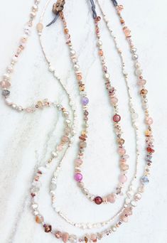 Three beautiful necklaces to choose from. First, this bold chunky necklace stocked with a variety of shapes, sizes, textures, and finishes. Opals, crystal, glass, and pearls. Elegant and and natural...pinks, fushia, purple, browns, oranges, soft mustards, maroons, ruby, rose, salmon, a beautiful sangria. Opals, Moonstone, pink shell, Aventurine, several Agates and Jaspers, Pearls, Sunstone, Ruby, Strawberry and Rose Quartz, Citrine, recycled Czech beads, Howlite, and more mixed in with delicate Long Single Strand Crystal Necklace For Jewelry Making, Pink Bohemian Crystal Necklace With Faceted Beads, Pink Bohemian Crystal Necklace With Gemstone Beads, Bohemian Pink Crystal Necklace With Faceted Beads, Bohemian Pink Crystal Necklaces With Faceted Beads, Bohemian Pink Crystal Necklace With Gemstone Beads, Bohemian Pink Gemstone Bead Necklaces, Rose Quartz Faceted Beads Necklace, Rose Quartz Necklace With Faceted Round Beads