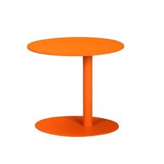 an orange round table sitting on top of a white floor