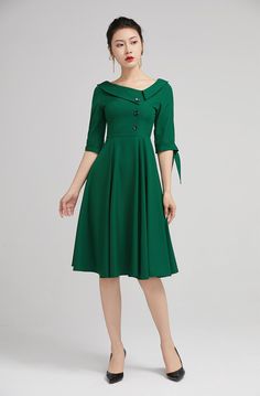 "The green swing dress with lapel collar is made of high quality polyester. The full cut romantic knee-length skirt with pleating details sways gently with every step. The tailored fitted bodice with a hidden side zip, defines the bust and waist. The elbow length sleeves are finished off with tie belt cuff. A row of buttons in the front and the Lapel Collar gives our classic dress timeless vintage charm, striking just the right balance between elegance and comfort. DETAILS * Satiny fabric, conta Classy Green Dress, Ideas Style Outfit, Linen Frocks, Midi Dress A Line, Cocktail Dress Classy Evening, Elegant Dresses Classy Vintage, Green Dress Outfit, Cocktail Dress Classy, Vintage Midi Dress