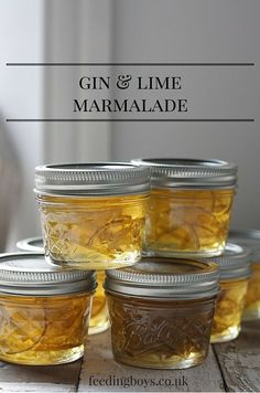 six jars filled with honey sitting on top of a wooden table