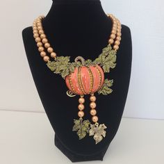 Retired Heidi Daus Necklace Pumping  Orange Enamel with Green Crystals and Goldtone Pearls. Stunning massive necklace with beautiful details and intricate design.   Bronze Metal frame, Crystal orange, pink, green, goldtone beads. Luxurious necklace signed Heidi Daus. In pristine pre-owned condition.  Please note, the size of the bust is smaller than average, and the necklace position on the body might differ from how it's pictured. For new arrivals check out the store's Instagram account https:/ Exquisite Pink Necklace For Gift, Luxury Pink Jeweled Jewelry, Decorative Pink Jewelry Gift, Exquisite Pink Pendant Necklace, Luxury Handmade Orange Jewelry, Unique Rose Gold Round Necklace, Pink Pendant Necklace With Jewels, Unique Necklaces With Detachable Pendant, Decorative Costume Jewelry Pendant