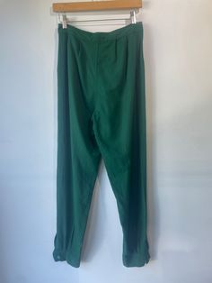 Electric Feathers Green Raw Silk Noil Trousers. Size Small. Button fixtures at bottom. Approximate measurements:Waist: 14"Inseam: 29" Classic Tapered Leg Bottoms With Buttons, Classic Bottoms For Daywear, Classic Long Pants For Daywear, Solid Full Length Bottoms For Daywear, High Waist Bottoms With Belt Loops For Daywear, Green Long Pants For Workwear, Full Length Pants With Buttons For Workwear, Straight Leg Bottoms With Belt Loops For Daywear, Relaxed Fit Bottoms With Button Cuffs For Daywear