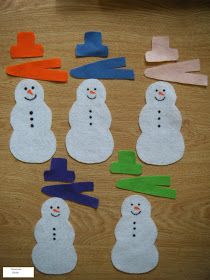 paper snowmen and carrots cut out on a table