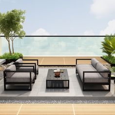 an outdoor living area with couches and tables