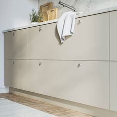 a white towel hanging on the side of a cabinet