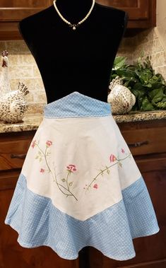 a woman's apron on display in a kitchen