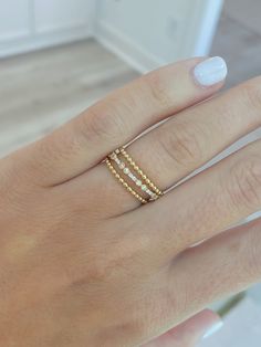 Add this delicate beaded design 14K gold band to any finger --- it is easiest ring to layer into your everyday jewelry routine! Dainty 14k Gold Midi Rings With Diamond Cut, Elegant 14k Gold Filled Yellow Stackable Rings, Elegant 14k Gold-filled Yellow Stackable Rings, Elegant Yellow Gold Stackable Rings, 14k Gold Filled, Timeless 14k Gold Stackable Midi Rings, Dainty Stackable Rings With Simple Design, Dainty Diamond Stackable Rings For Everyday, Dainty Stackable Bands, Elegant Adjustable Stackable Rings In 14k Gold Filled