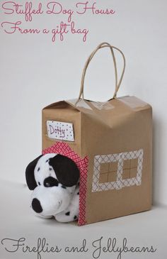 a stuffed dog in a cardboard box with a tag on it's side and the words, stuffie bag house from a gift bag