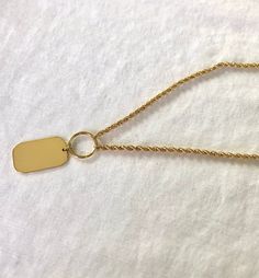 Delicate 14k yellow gold dog tag... Chain is adjustable to any length you prefer.. chain is a 2mm rope chain. Personalization is available, please specify what you would like to have engraved on the tag. Weight is 4.9 grams Width of Tag in Length is 2.8mm and Height is 10mm Width of Chain is 2mm Length of Chain is 20 Inchs Gold Tag Necklace, Gold Dog Tag, Gold Tag, Engraved Dog Tags, Disc Pendant, Gold Gift, Rose Gold Bracelet, Cuban Link Chain, Yellow Gold Chain