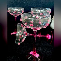 three wine glasses with pink flowers on them