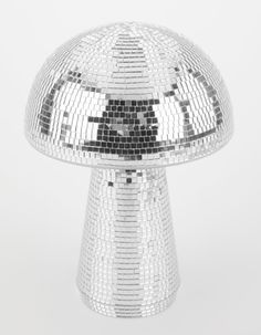 a shiny silver mushroom shaped object sitting on top of a table