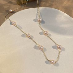 ✦ Channel timeless beauty with our Dainty Pearl Link Chain Necklace. This delicate necklace features a stunning link chain embellished with exquisite pink pearls, creating a harmonious blend of elegance and femininity. The pearls dangle gracefully along the chain, adding movement and allure to the design. Whether you're dressing up for a romantic date or adding a touch of refinement to your everyday attire, this pearl link chain necklace is a stunning and versatile accessory that will enhance your style. - Color: Ivory / Pink - Materials: Alloy, Gold Plated, Faux Pearl - Necklace Length: 47.6cm - SKU: HN1120 Necklace Clasp, Pearl Chain Necklace, Pink Pearls, Basic Jewelry, Necklace Clasps, Romantic Date, Crystal Hoop Earrings, Nose Rings Hoop, Link Chain Necklace