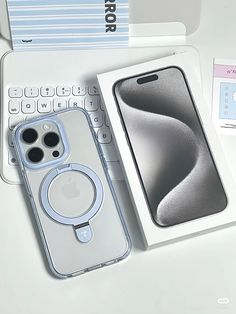 an iphone case sitting on top of a laptop computer next to a keyboard and mouse