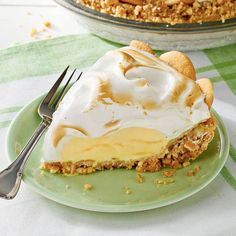 a green plate topped with a piece of pie covered in icing next to a fork