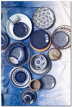 many plates and bowls are arranged on a table