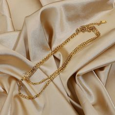 This Layered Gold Figaro Necklace, with its 18k gold-filled layers, brings a sophisticated flair. Its classic Figaro chain design offers timeless elegance, perfect for enhancing both everyday and formal ensembles. Multi-strand Figaro Chain Necklaces For Layering, Elegant Multi-strand Gold Necklace, Elegant Gold Multi-strand Necklace, Multi-strand Figaro Chain Necklace, Elegant Multi-strand Figaro Chain Jewelry, Dainty Multi-strand Layered Necklace With Figaro Chain, Classic Gold Layered Necklace With Clavicle Chain, Elegant Double Strand Gold-tone Necklaces, Elegant Double Strand Gold-tone Necklace