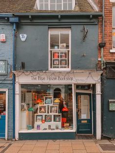 the blue house bookshop is located in an old brick building with many windows and doors