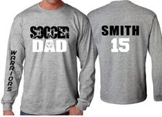 Soccer Dad Shirt | Soccer Long sleeve (one sleeve/one word only) Shirt | Customize your team & colors PLEASE READ BEFORE ORDERING WE CANNOT RUSH ORDERS OR CREATE NEW DESIGNS DURING PEAK SEASON AUG - MAY. IF YOU NEED TO CANCEL PLEASE DO SO WITHIN 24HRS Please read full description before ordering we cannot be responsible for mistakes made by not reading the full description. ORDERING INSTRUCTIONS: 1. Select your Garment Size/Color Each size must be selected separately. Please do NOT leave a l Athletic Heather Long Sleeve T-shirt With Letter Print, Long Sleeve T-shirt With Team Name For Sports Season, Team Name Long Sleeve T-shirt For Baseball Season, Sports Fan Long Sleeve T-shirt For Baseball Season, Long Sleeve Sports Fan T-shirt For Baseball Season, Long Sleeve T-shirt For Baseball Season, Long Sleeve Team T-shirt For Football Season, Long Sleeve Tops With Team Name For Sports Events, Varsity Tops With Letter Print For Team Events