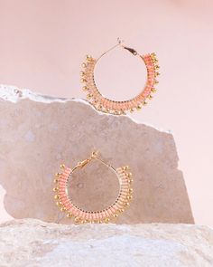 These beaded hoop earrings combine delicate premium Japanese Miyuki glass beads with gold drop accent beads for a fun and whimsical everyday hoop. Three ombre tones of beads are woven one bead at a time around a gold-filled hoop base with a lever back closure for easy on and off use. Our earrings are handmade by women artisans in Medellin, Colombia who receive fair working conditions and compensation for their skills. Materials: Miyuki Glass Beads Gold Filled Hoop Earring Base Size: Length 1.5 I Trendy Gold Beaded Earrings With Dangling Beads, Pink Hoop Beaded Earrings With Tiny Beads, Adjustable Gold Hoop Earrings With Faceted Beads, Pink Tiny Beads Hoop Earrings, Trendy Gold Beaded Earrings, Summer Faceted Beads Earrings, Summer Tiny Beads Small Hoop Earrings, Summer Tiny Beaded Small Hoop Earrings, Gold Beaded Hoop Earrings For Summer