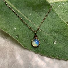 "The Morning Dew Drop Necklace is inspired by the beauty of nature. It has the perfect Summer Aesthetic that goes with everything. It is one of the smallest pendants that I make. The glass used is Crystal Clear with a dichroic glass with a delicate iridescence that changes in color. The sparkle is subtle and simple and changes depending on the lighting and the colors behind the glass. This is a great size for everyday wear or to layer with other designs. Chains: Cable Chain and Satellite Chain. Nature Inspired Jewelry Necklaces, Dewdrop Aesthetic, Adjustable Minimalist Teardrop Pendant Charm Necklaces, Minimalist Wire Wrapped Charm Necklaces As Gift, Minimalist Wire Wrapped Charm Necklace Gift, Minimalist Wire Wrapped Charm Necklace For Gift, Iridescent Teardrop Pendant Necklace For Gift, Minimalist Teardrop Pendant Crystal Necklace, Minimalist Teardrop Crystal Necklaces