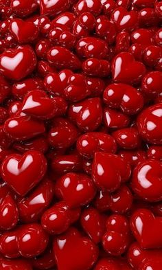 many red heart shaped candies are stacked together