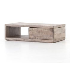 a wooden coffee table sitting on top of a white floor