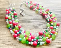 "Green & pink statement necklace with a fresh take on a Watermelon! The perfect statement - pair with a white tee, jeans, and your favorite purse OR a fancy dress that needs a certain something extra.  16\" Long plus a 4\" silver extender chain.  I ship 6 days a week! This particular necklace is ready to ship! Thank you for browsing my store!" Pink Necklaces With Colorful Beads For Spring, Pink Round Beads Necklace For Spring, Trendy Green Necklace With Colorful Beads, Trendy Green Necklaces With Colorful Beads, Trendy Pink Beaded Necklace For Spring, Spring Pink Round Bead Necklaces, Trendy Green Necklace For Spring, Casual Pink Beaded Necklaces For Spring, Green Necklaces With Round Beads For Spring