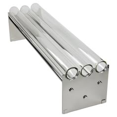 four clear tubes are attached to the side of a stainless steel wall mounted shelf with three round glass knobs on each end