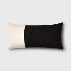 a black and white pillow on a gray background with the color block at the bottom