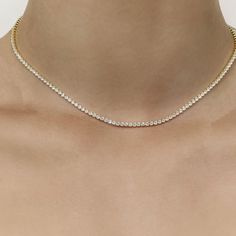 The Core Classic Diamond Tennis Necklace embodies timeless elegance. Crafted in 14ct vermeil on sterling silver, this necklace features prong-set 2mm cubic zirconia that drapes gracefully, ensuring it stays in perfect proportion without flipping. Adjustable from 16.25 to 18.25 inches, it offers both comfort and versatility, making it ideal for everyday wear or special occasions. Material: 14ct Vermeil on Sterling Silver Stone: 2mm Round Cubic Zirconia, Prong Set Length: Adjustable 16.25-18.25 in Tennis Diamond Necklace, Romantic Classic, Diamond Tennis Necklace, Jewelry Staples, Real Real, Tennis Necklace, Silver Shop, Ring Bracelet, Earring Necklace