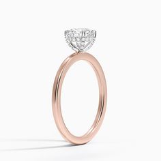 a rose gold engagement ring with a diamond center