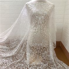 Heavy embroidered lace fabric with an amazing design and high quality about that product Dimensions Length: 1 Yards; Width: 51 Inches Primary fabric: Tulle Primary fiber: Polyester Secondary fiber: Polyester Color: off-white ❀❀ About the sample❀❀ If you need to check the quality and pattern of the lace fabric, we can provide you with a small sample; when you confirm the order, we will refund the sample fee for you. Perfect for dress making, bridal wear, wedding gown, bodice or curtains ❀❀ MEASUR Embroidered Wedding Gown, Pallas Couture, White Lace Fabric, Beaded Lace Fabric, Bridal Lace Fabric, Tulle Flowers, Embroidered Lace Fabric, Wedding Dress Fabrics, Embroidered Wedding