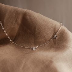 Our delicate Love Notes Necklace is a thing of exquisite beauty and meaning. Its subtly asymmetrical design evokes grace and refinement, while also carrying your most cherished people close to your heart. As we create our jewellery by hand, there will always be variation in alignment and spacing. The beauty of this process is that each KBN piece is unique to its wearer. Asymmetrical Necklace, Rectangle Necklace, Oval Necklace, Symbol Necklace, Zodiac Necklaces, Asymmetrical Design, Love Notes, Gold Filled Jewelry, Bar Necklace