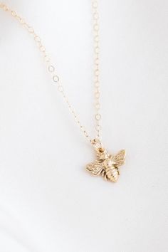 This little gold pendant necklace is dainty and sweet! Our Honey Bee Necklace features a teeny little bee, suspended on a gorgeous cable chain. We love it paired with our Queen Bee Necklace. Gold filled or sterling silver - it's perfect for everyday wear without tarnishing. AND it's affordable. Find more at Simple & Dainty! Cute Charm Necklaces With Adjustable Chain For Gift, Cute Charm Necklace With Adjustable Chain For Gift, Cute Necklace With Adjustable Chain For Gift, Cute Necklace With Adjustable Chain As Gift, Cute Adjustable Chain Necklace For Gift, Handmade Delicate Charm Necklace For Everyday, Cute Everyday Necklace With Adjustable Chain, Cute Everyday Pendant Charm Necklaces, Handmade Cute Charm Necklaces