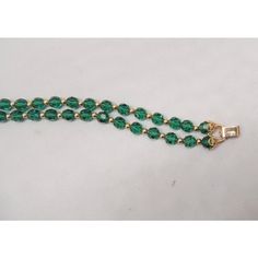 This is part of Chairish’s Costume Jewelry assortment.  Goldtone two strand cut green glass beads with round goldtone smaller spacer beads and filigree details near the fold over clasp. Marked "Napier." Measures: 7 5/8 inches long by 3/4 inches wide. Excellent condition. An identical bracelet except with red glass beads is shown on pg. 370 of Melinda L. Lewis & Henry Swen's book "The Napier Co.: Defining 20th Century American Costume Jewelry." Dates to 1963. Glass Beaded Bracelets, Red Glass, Spacer Beads, Green Glass, Vintage Signs, Costume Jewelry, Gold Tones, Glass Beads, Beaded Bracelets