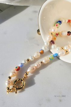 This beautiful Pearl & Millefiori Necklace is the most trendy, affordable and high-quality handmade piece you ever have, is made of Freshwater Pearls, and glass millefiori beads, each necklace is beaded in a unique pattern, which means each necklace is different from others, this delicate design makes it perfect for an effortless look 💕 Multicolor Pearl Charm Jewelry As Gift, Multicolor Pearl Charm Jewelry Gift, Multicolor Jewelry With Pearl Charm For Gift, Multicolor Jewelry With Pearl Charm As Gift, Multicolor Pearl Charm Necklace For Gifts, Multicolor Necklaces With Pearl Charm As Gift, Flower Shaped Single Strand Beaded Necklace For Gift, Flower Shaped Single Strand Jewelry For Gifts, Flower Shaped Single Strand Necklace For Gift