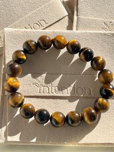 Tiger's Eye Crystal Bracelet, Gemstone Jewelry, Tigers Eye Healing Crystal, Handmade Unisex Bracelet Christmas Gift For Him, Gift For Her 💕Product Description💕 Each bead is a touchstone for courage, confidence, and clarity. Handmade with love in the USA, this bracelet is more than just jewelry; it's a daily reminder of your inner strength. Size: 10mm (one size fits all) Benefit: to enhance courage and self-confidence By wearing this crystal bracelet: you are setting your intention for the day! Tiger's Eye Crystal, Christmas Gift For Him, Bracelet Christmas, Tiger Eye Crystal, Healing Crystal Jewelry, Christmas Gifts For Him, Bracelet Gemstone, Unisex Bracelets, Tigers Eye