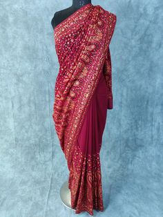 Kashmiri Embroidered Saree on Georgette with thread embroidery and some stones Fabric:  Georgette Length: 5.5 Meters | 6.1 yards Colour: Wine Blouse: Saree comes with blouse fabric. Base Color is same as Saree with border for sleeves or however you desire Please see product video for product details. If you have any questions message us anytime. Fall and Edging will be done complimentary.  Blouse Stitching (If Requested): Blouse will be stitched according to your measurements, which we will ask Thread Work Saree Embroidery, Traditional Pre-draped Saree With Dori Work For Eid, Traditional Embroidered Chanderi Pre-draped Saree, Traditional Drape Blouse For Reception With Cutdana, Navratri Pre-draped Saree With Resham Embroidery, Bollywood Style Embroidered Pre-draped Saree For Diwali, Embroidered Pre-draped Saree For Navratri Reception, Embroidered Pre-draped Saree For Reception And Navratri, Diwali Embroidered Pre-draped Saree For Reception