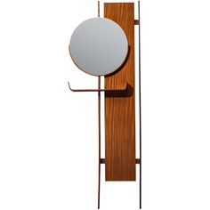 a mirror on a wall next to a coat rack with a round mirror hanging from it's side