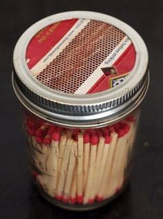 a jar filled with matches on top of a table