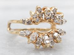 two yellow gold rings with diamonds on each one and the other in different shapes, sizes and colors