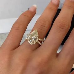 a woman's hand with an engagement ring on it and a diamond in the middle