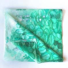 Jade silk scarf, hand paint with silk paint in green and turquoise shades on white. Size: 61 by 17 inches Silk: pure Habotai Light, semi transparent and a bit glossy This long, light scarf is ready to be shipped! It is hand painted with special silk paints that can be washed (for silk sake, please wash by hand! I am attaching an easy-to-follow instruction). The scarf won't fade! On this white and green silk wrap I have painted jade plant (you know it? Super popular indoor Crassula plant that bri Green Hand Dyed Bohemian Scarf, Green Silk Scarves For Summer, Handmade Green Bohemian Silk Scarf, Handmade Bohemian Green Silk Scarf, Artistic Hand-dyed Green Scarves, Elegant Handmade Green Silk Scarf, Artistic Hand Dyed Green Silk Scarf, Hand Painted Green Silk Scarf, Green Bohemian Silk Scarf For Gift