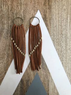 These boho earrings are the perfect addition to any outfit. Made with beautiful camel leather that will age well over time and gold details on the leather. Before shipment the earrings will be finished with 24k gold earring closures. Brown Brass Dangle Earrings, Brown Tassel Earrings For Festivals, Brown Brass Drop Earrings, Gold Tassel Earrings For Festivals, Elegant Brown Adjustable Tassel Earrings, Elegant Brown Brass Earrings, Handmade Brown Hoop Earrings For Everyday Wear, Brown Dangle Earrings With Tassels, Everyday Handmade Brown Hoop Earrings