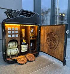 an open suitcase with bottles and corks on the inside is lit up by lights