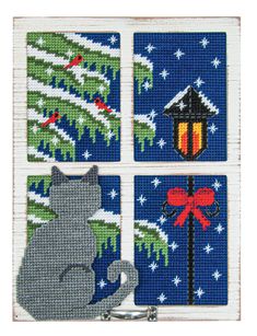 four cross stitch coasters with cats and christmas trees