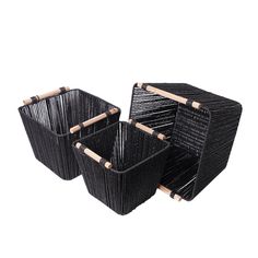 three black baskets with bamboo handles on each side and one is holding two large ones